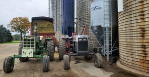 tractors next to grain silos