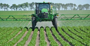 sprayer operator applies a herbicide 