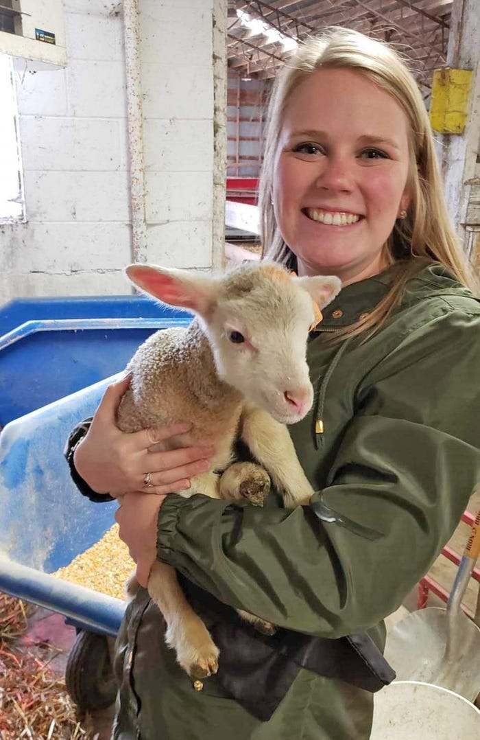 Abigail Martin holding a lamb at UW-Madison Sheep Research facility