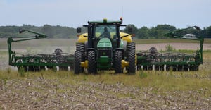 tractor and planter in field planting soybeans