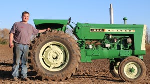 Derek Griep from Rubicon, Wis., standing next to his 1967 Oliver 1550 tractor