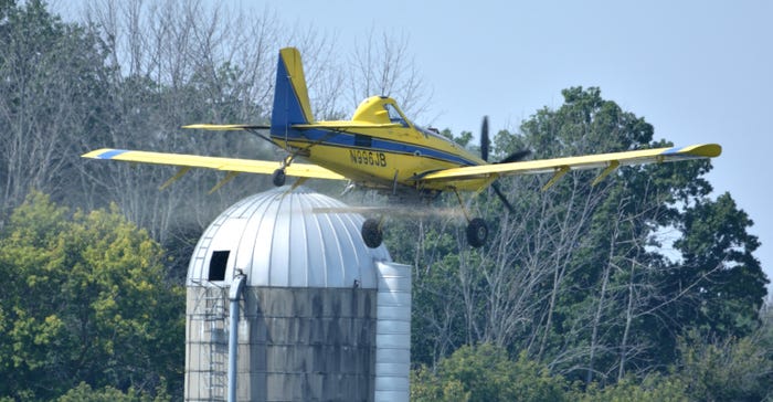 plane flying near silo