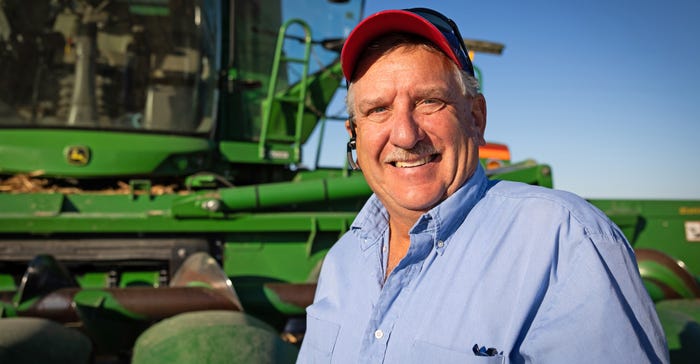 Illinois Farm Bureau Vice President Brian Duncan standing in front of combine