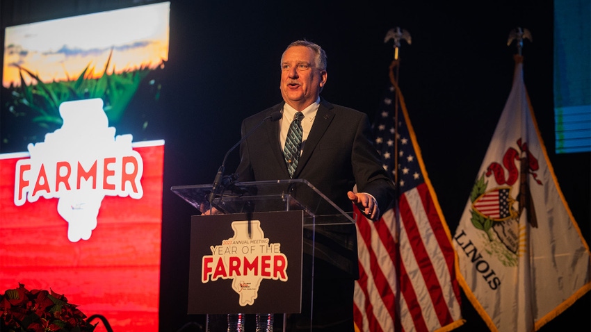 Brian Duncan, the 2023 Illinois Farm Bureau president, behind a podium as he speaks into a microphone