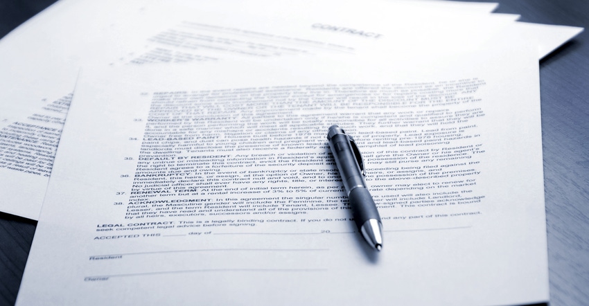 contracts on table with pen laying on top