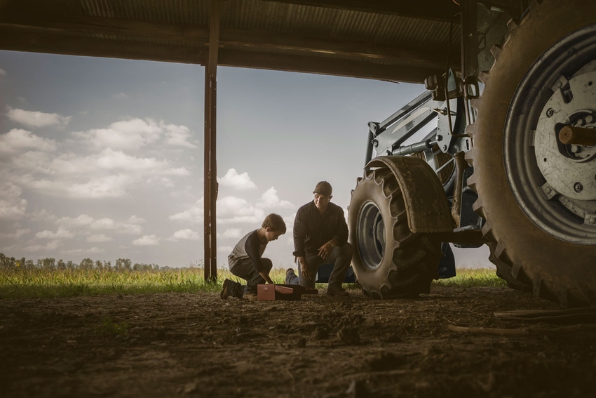 father-son-working-on-tractor-GettyImages-470622691.jpg