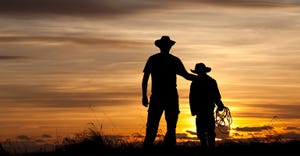 Father and son silhouette in sunset