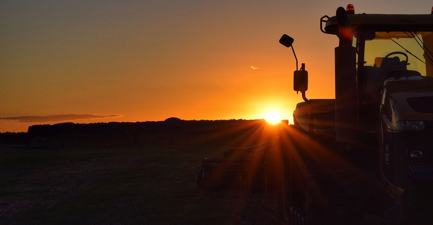 silhouette of tractor at sunset
