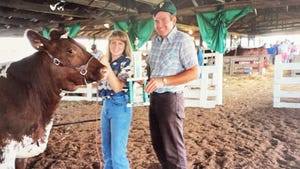 1993 photo of Don St Ledger presenting a trophy to Holly Spangler as she holds a beef cow close to her
