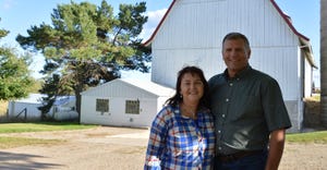 Leslie and Susan Kleiman standing infront of family barn