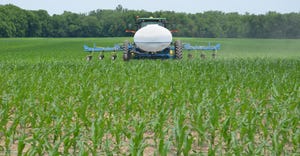 sprayer applying liquid nitrogen to corn crop