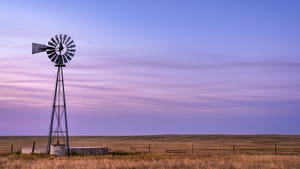 Windmill on prairie at sunrise