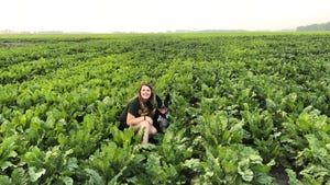 Sarah McNaughton in field with dog