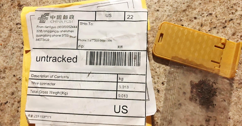 A manila colored package shipped from China with a bag of seeds next to it on a counter top