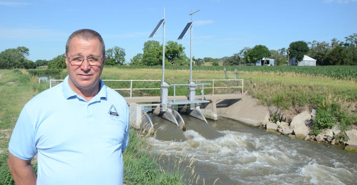 Brad Edgerton, Frenchman Cambridge Irrigation District general manager, stands in front of a FlumeGate on the Cambridge Canal