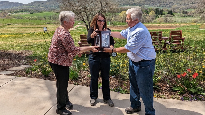 Darlene Livingston and Rachael Sattazahn hand John Vogel the organization’s first-ever Founders Award