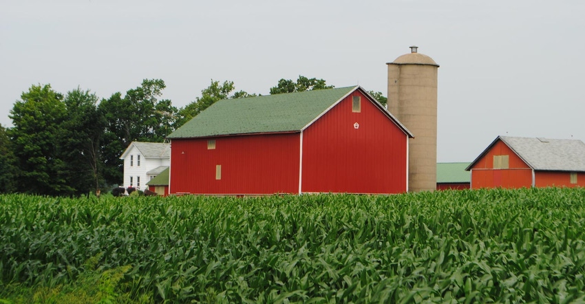 A farmstead with a red barn and white house