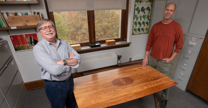  Mark Rasmussen and Chris Martin stand by conference table
