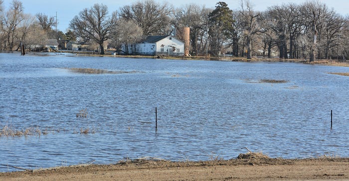 farmstead surrounded by floodwaters