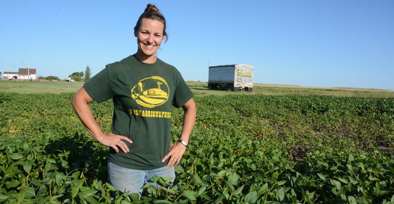 Carie Moore stands in soybean field