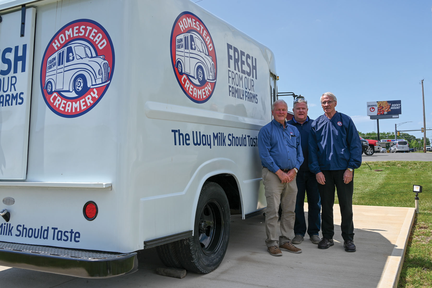 Co-founder Donnie Montgomery (left), President Walt Frazier and board member Dave Kohl pose beside a Homestead Creamery delivery truck