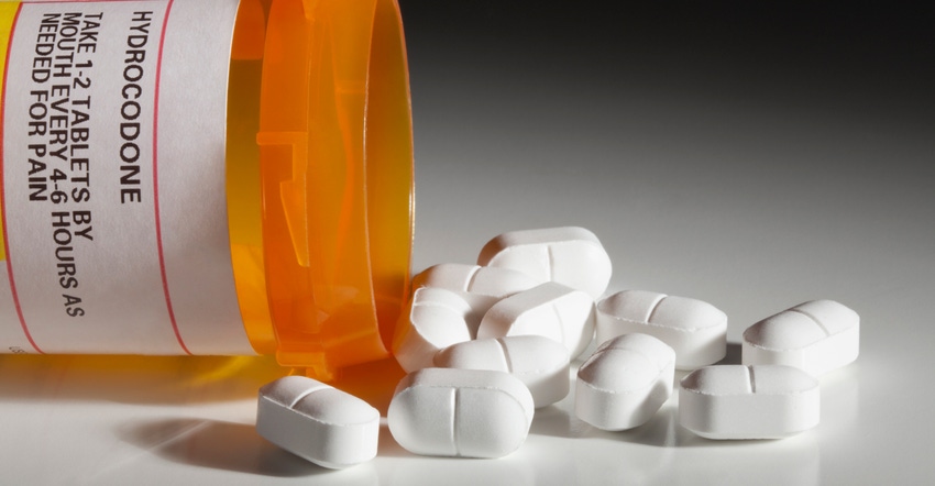 orange pill bottle with hydrocodone pills spilling out orange pill bottle with hydrocodone pills spilling out