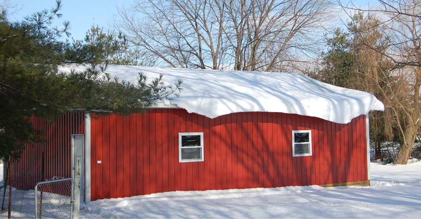 red pole barn covered in snow red pole barn covered in snow