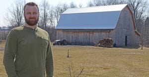 Justin Keiffer of Nashville, Mich., stands in front of his heritage-style barn 