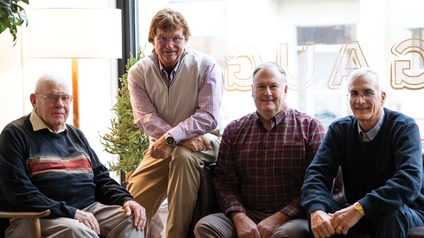 2023 Prairie Farmer Master Farmers sitting on couch in front of window