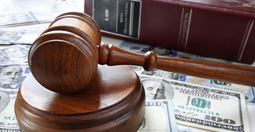 Gavel on money with law book in background