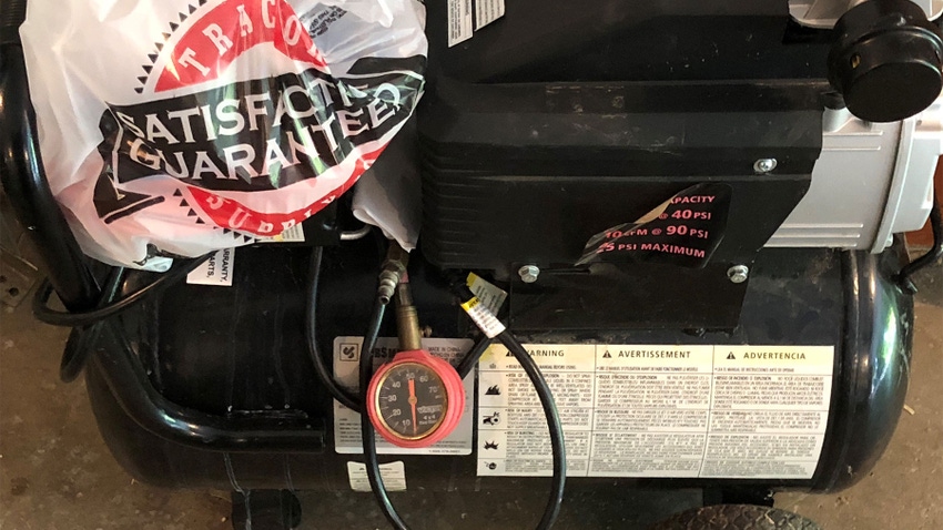 A close-up of a plastic bag sitting on top of an air compressor