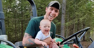 Gus Franchi of New Hampshire rides a tractor with his daughter Eleanor