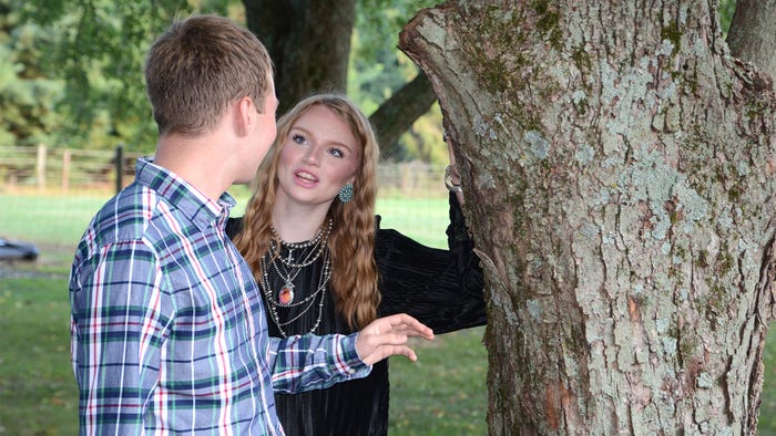 Blaine Wagner and Kelby Roberts chatting near a tree