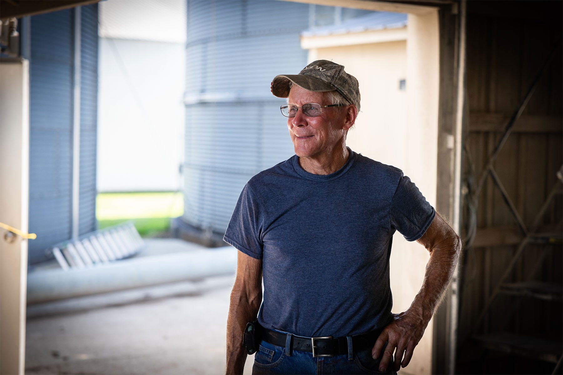Bill H. Voorhees stands inside a shed on his farm