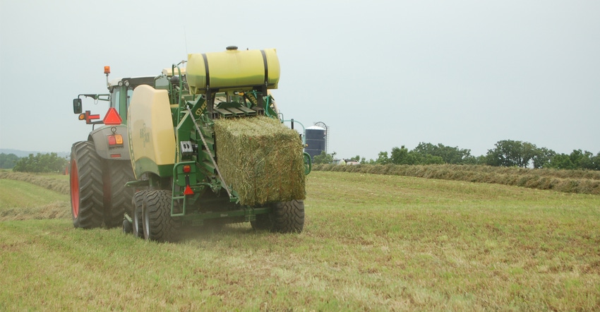 Tractor in field fertilizing pasture and hay ground Tractor in field fertilizing pasture and hay ground