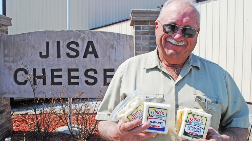 Dave Jisa holding several packages of Jisa Cheese
