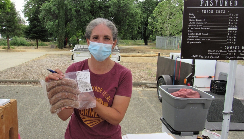 Audrey Pascone holding package of sausage