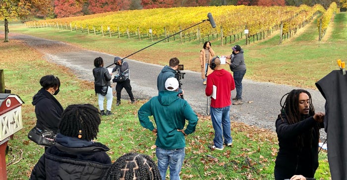 Filmmakers test sound and light before shooting a scene in front of the vineyard at Robin Hill Farm & Vineyards