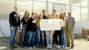 Members of WCA FFA chapter holding oversized check