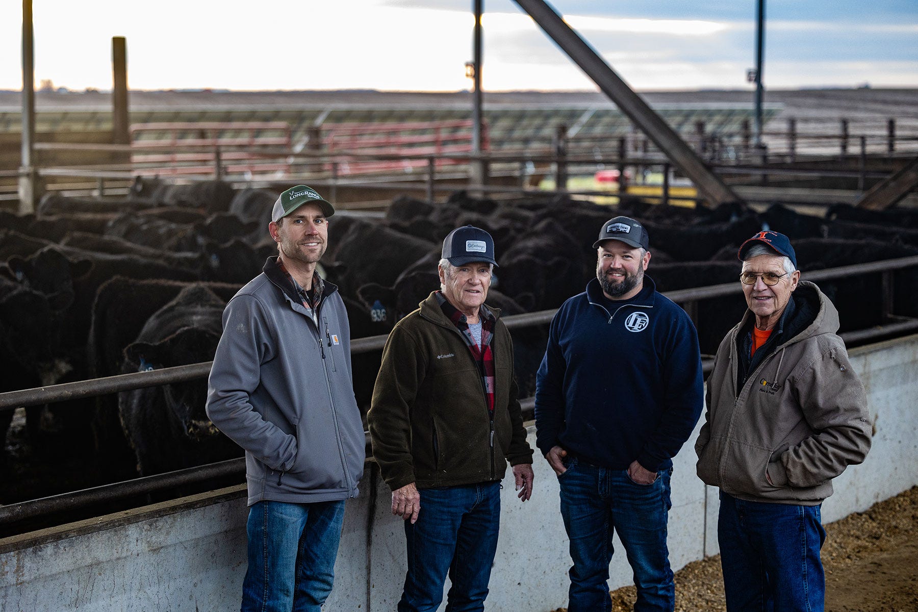 Dan, Lou, Nathan and John Lamoreux stand in front of a cowlot