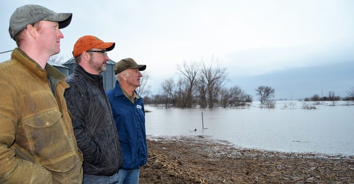 Spiegel family look across flooded field