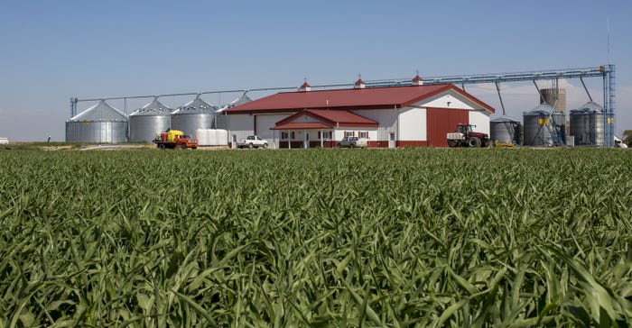 cornfield in front of Morton Buildings farm shop with grain center behind it cornfield in front of Morton Buildings farm shop with grain center behind it
