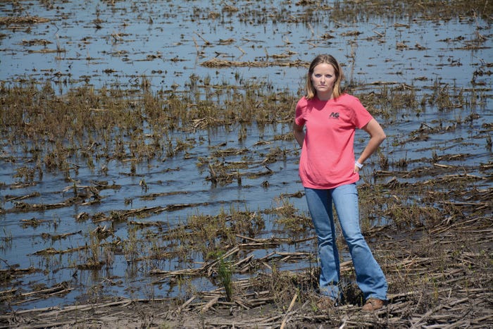 Farmer standing next to flooded field