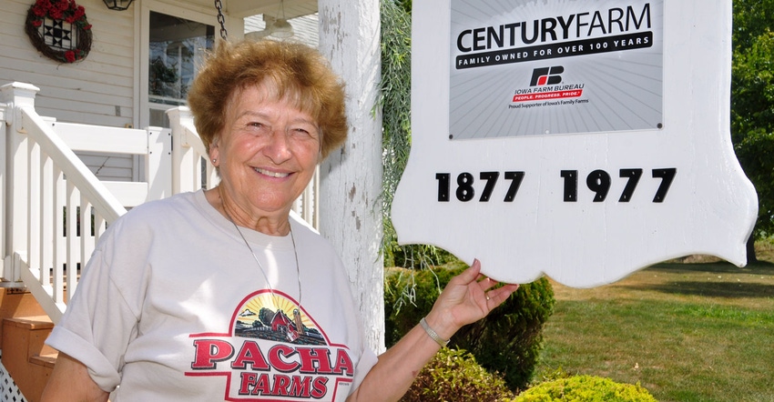 Rosemary Pacha stands beside the Pacha Century Farm sign