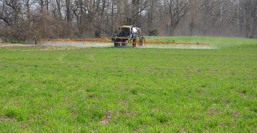sprayer in field covered in cover crops