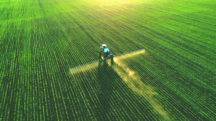 Sprayer in green field