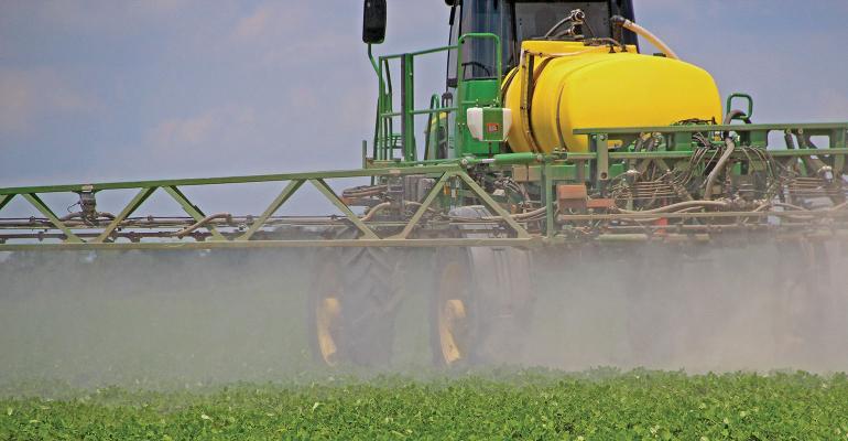 Tractor spraying a field.