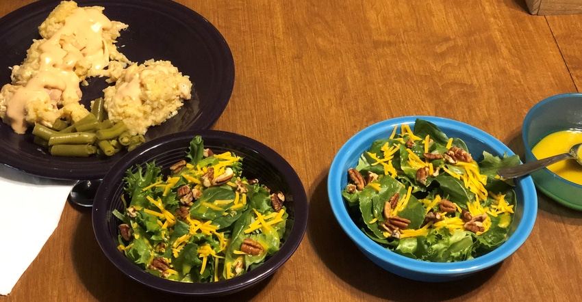 plated dinner and bowls of salad