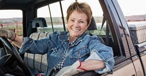 female rancher driving a truck