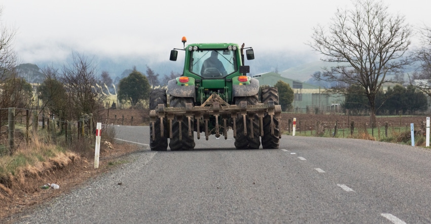 tractor driving down roadway